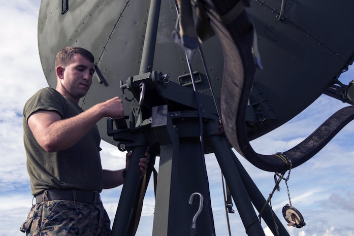 U.S. Marine Corps Cpl. Hunter Buley, Tropospheric Scatter Microwave Radio Terminal operator with Marine Wing Communications Squadron 18 adjusts the radio terminal's trajectory allowing it to receive and transmit data during Valiant Shield 16 at Andersen Air Force Base, Sept. 18, 2016.  The radio terminal provided uninterruptable communications between Guam and Tinian. VS16 is a biennial, U.S.-only, field training exercise that focuses on joint training with U.S. Navy, Marine Corps, and Air Force to increase interoperability and working relationships. 