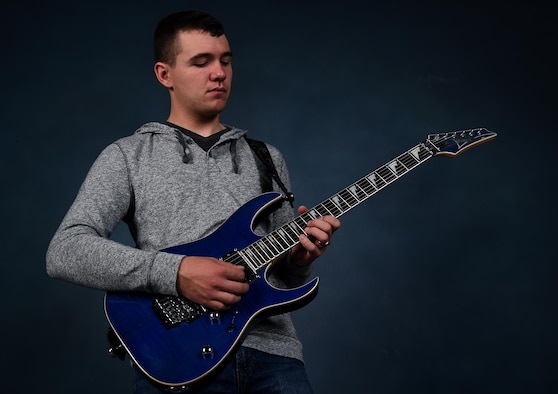 Airman 1st Class Zacary Heinzerling, 460th Security Forces Squadron apprentice, plays his guitar during a photoshoot September 8, 2016, at Buckley Air Force Base, Colo. In addition to the guitar, Heinzerling knows how to play the tuba, trombone, saxophone, piano, baritone and drums. (U.S. Air Force photo by Airman Holden S. Faul/ Released)