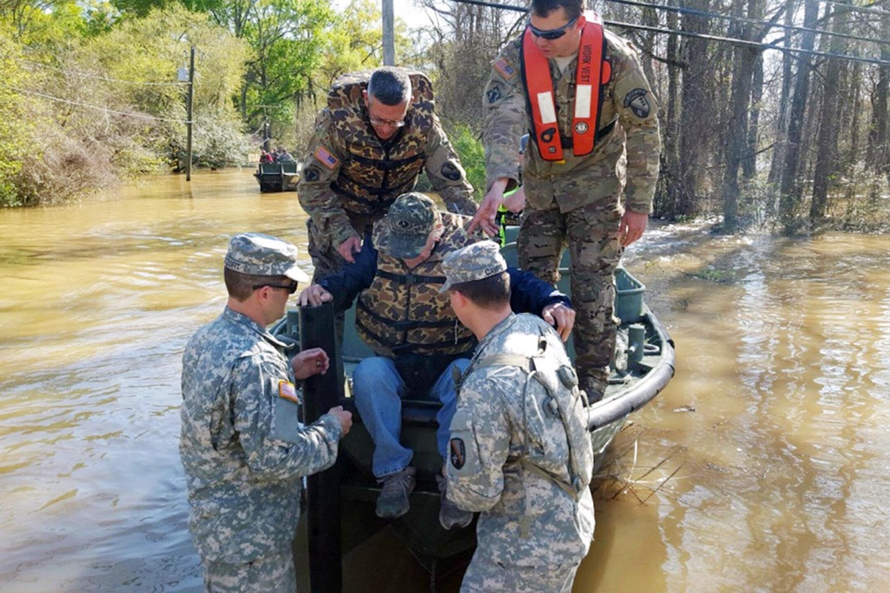 Louisiana National Guard soldiers with the 2225th Multi-Role Bridge Company, 205th Engineer Battalion, help a man out of the bridge erection boat they used to check on residents affected by flooding in Ponchatoula, La., March 13, 2016. Louisiana National Guard photo by 1st Lt. Rebekah Malone
