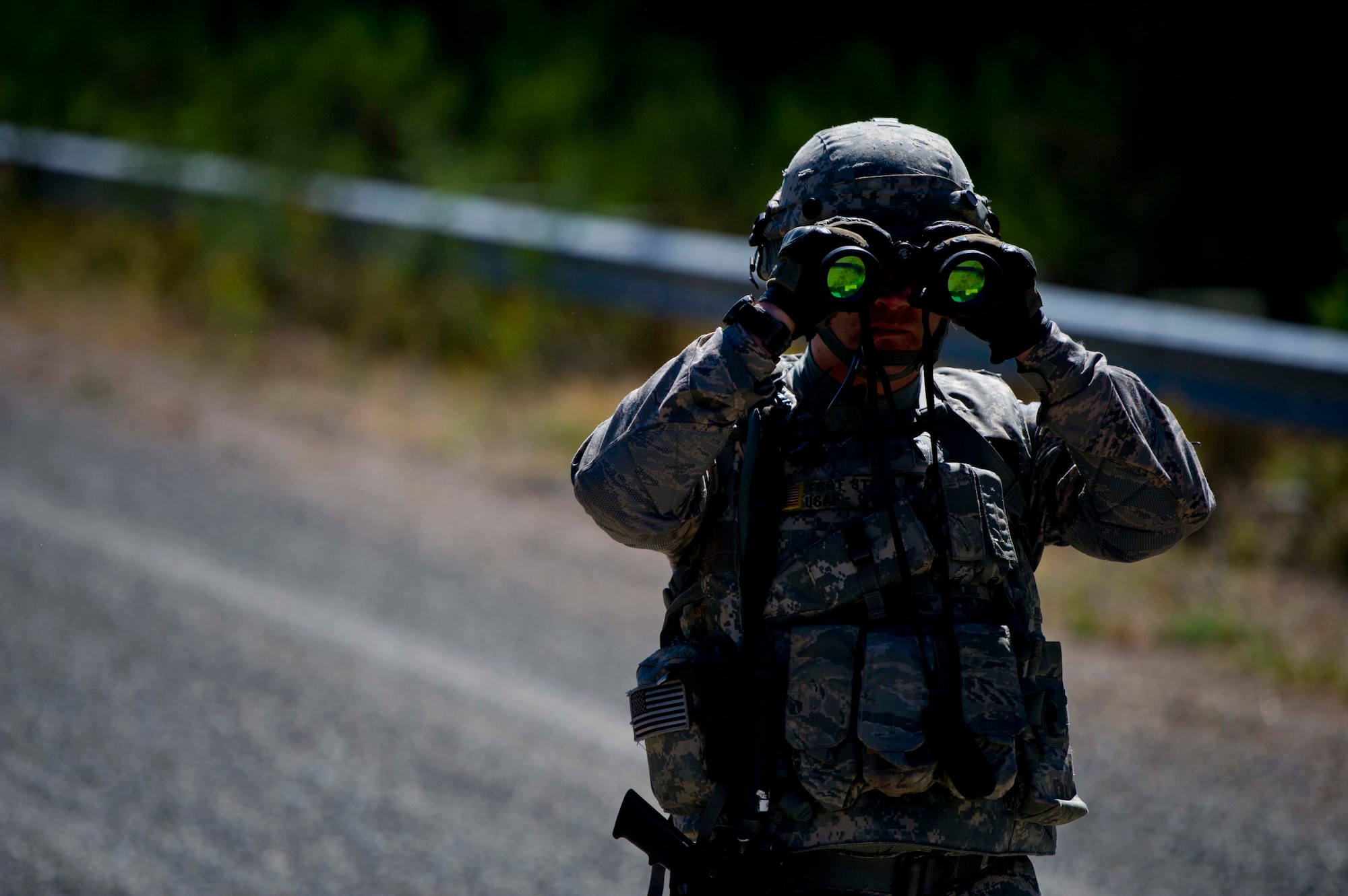 A Citizen Airman from the 446th Security Forces Squadron scans the area as part of a large-scale Field Training Exercise at Joint Base Lewis-McChord September 8 - 11th. The exercise focused on training Citizen Airmen on expeditionary tactics and procedures. (U.S. Air Force Reserve photo by Staff Sgt. Daniel Liddicoet)