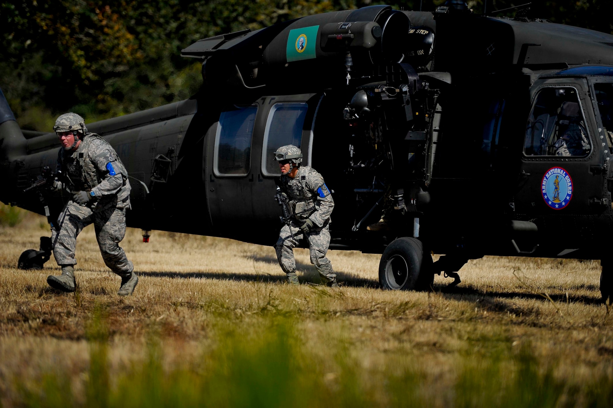 Two members from the 446th Security Forces Squadron arrive for the expeditionary exercise from a U.S. Army UH-60 Black Hawk helicopter. The expeditionary exercise kicked off over the September Unit Training Assembly and concluded Sept. 11. (U.S. Air Force Reserve photo by Staff Sgt. Daniel Liddicoet)