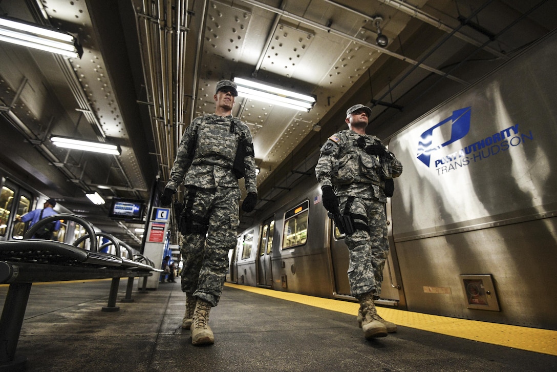 New York Army National Guard Spcs. Robert Hunt, left, and Jakub Jakubowski patrol the 33rd Street subway station in New York City, Sept. 20, 2016, following the recent bombings in Manhattan and New Jersey. The soldiers are members of Joint Task Force Empire Shield, which works with 53 local, state and federal partners to provide military support to civil authorities. New York Air National Guard photo by Staff Sgt. Christopher S Muncy