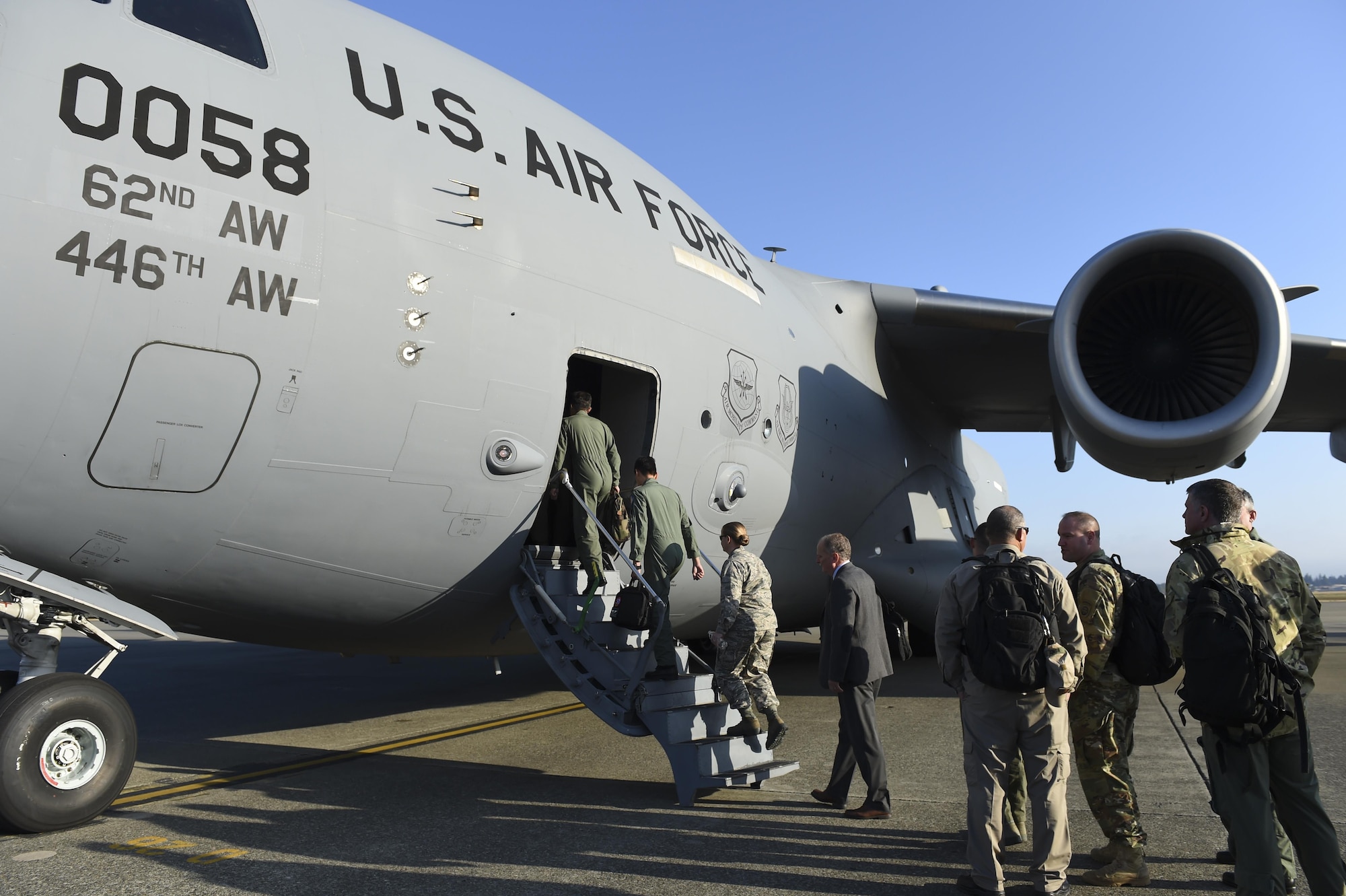 Air crew members from Belgium, the United Kingdom, New Zealand, Pakistan, Canada, Taiwan, Brazil and Australia load onto a McChord C-17 Globemaster III Sept. 21, 2016, as part of Air Mobility Command’s Mobility Guardian in progress review at Joint Base Lewis-McChord, Washington. The group flew with Mobility Guardian planners to the various sites where the exercise will take place. (Air Force photo/ Staff Sgt. Naomi Shipley)