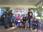JOINT BASE PEARL HARBOR, HI - Sailors from the Virginia-class fast-attack submarine USS North Carolina (SSN 777) and students from Hale Keiki school pose for a photo after renovating the school with weekly cleaning, painting and maintenance. 