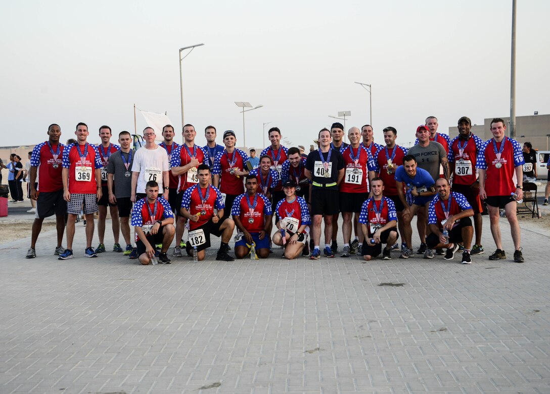 Participants pose for a photo after completing either the half or full marathon during the 20th annual Air Force Marathon Sept. 17, 2016, at Al Udeid Air Base, Qatar. A total of 673 deployed members from different branches of the military and Coalition partners participated in this year’s race. (U.S. Air Force photo/Senior Airman Melissa Buonanducci/Released)