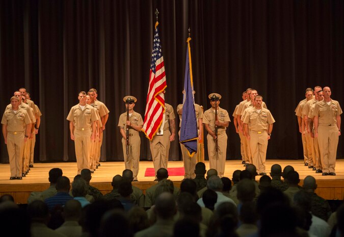 The Naval Color Guard presents the colors in front of the newest Sailors to be promoted to Chief Petty Officer at the base theater on Marine Corps Base Camp Lejeune, Sept. 16. The ceremony happened at the end of a six weeks transition period for Petty Officers 1st Class in to Chief Petty Officers where they are given first-hand knowledge on what it means to be a Chief in the Navy. (U.S. Marine Corps photo by Lance Cpl. Tavairus /Released)