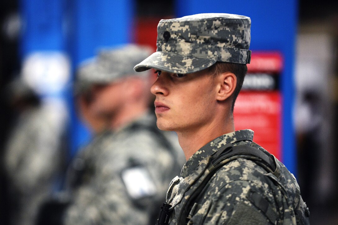 A New York Army National Guardsman observes pedestrian traffic at the 33rd Street subway station in New York City, Sept. 20, 2016, following the recent bombings in Manhattan and New Jersey. New York Air National Guard photo by Staff Sgt. Christopher S. Muncy


