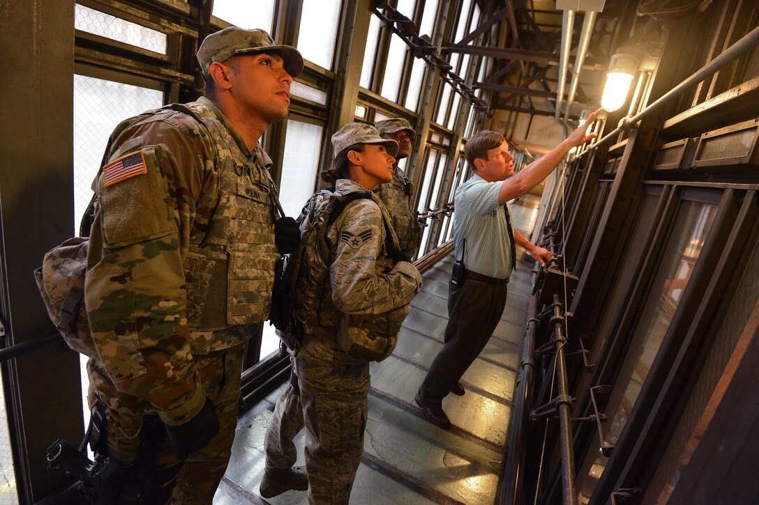 New York Air National Guard Senior Airman Ashley Espin, center left, and New York Army National Guard Spcs. Casimir Remond, center right, conduct a security patrol with a staff member at Grand Central Station in New York City, Sept. 20, 2016, following the recent bombings in Manhattan and New Jersey. Espin, Remond and Molina are members of Joint Task Force Empire Shield. Air National Guard photo by Staff Sgt. Christopher S. Muncy
