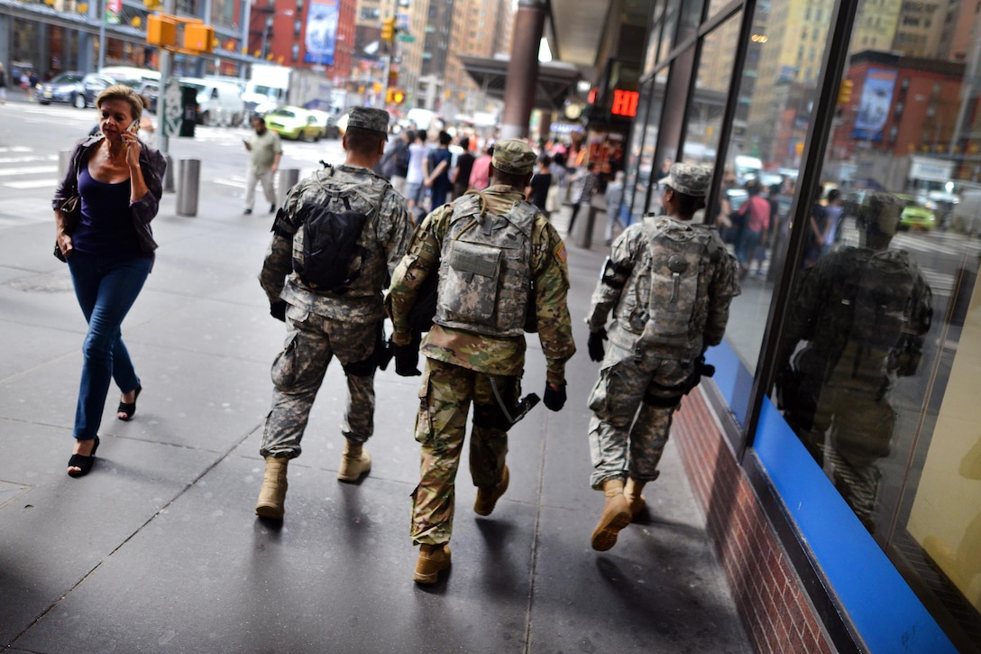 New York Army National Guard Sgt. David Licorish, Spc. Luis Gustav Postigovalverde, and Pfc. Dion Hani Martin patrol at the Port Authority Bus Terminal in New York City, Sept. 21, 2016, following the recent bombings in Manhattan and New Jersey. Licorish, Postigovalverde, and Martin are members of Joint Task Force Empire Shield. New York Air National Guard photo by Staff Sgt. Christopher S. Muncy
