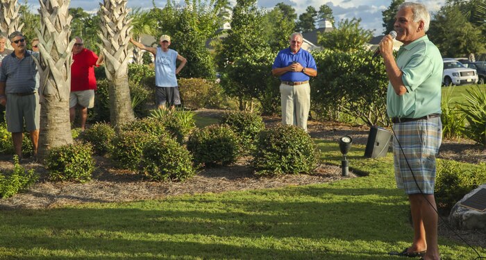 Robert Tertzakian, right, retiree, talks to the crowd about his heart attack and the gratitude he has for Gunnery Sgt. Raymond Andresen, who saved his life on the Magnolia Greens Golf Course at Leland, North Carolina, Sept. 15. Andresen, a Marine with Marine Aviation Logistic Squadron 29, was awarded the Navy Achievement Medal for his immediate actions in handling Tertzakian’s heart attack in May. (Photo by Lance Cpl. Tavairus Hernandez/Released)