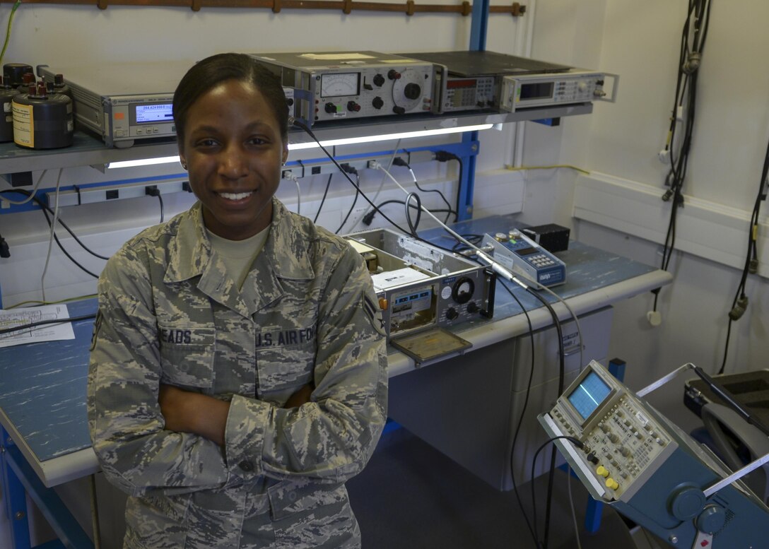 U.S. Air Force Airman 1st Class Shannon Meads, 100th Operations Support Squadron Airfield Systems technician, poses for a photograph in her work center Sept. 22, 2016, on RAF Mildenhall, England. Meads was submitted for the SquareD Spotlight for being an outstanding member of Team Mildenhall. (U.S. Air Force photo by Staff Sgt. Victoria Taylor) 