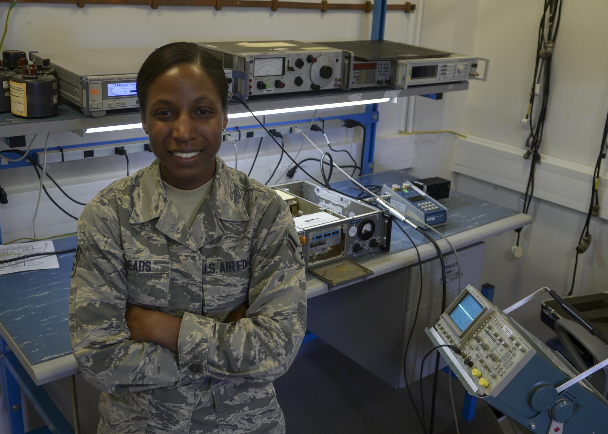 U.S. Air Force Airman 1st Class Shannon Meads, 100th Operations Support Squadron Airfield Systems technician, poses for a photograph in her work center Sept. 22, 2016, on RAF Mildenhall, England. Meads was submitted for the SquareD Spotlight for being an outstanding member of Team Mildenhall. (U.S. Air Force photo by Staff Sgt. Victoria Taylor) 