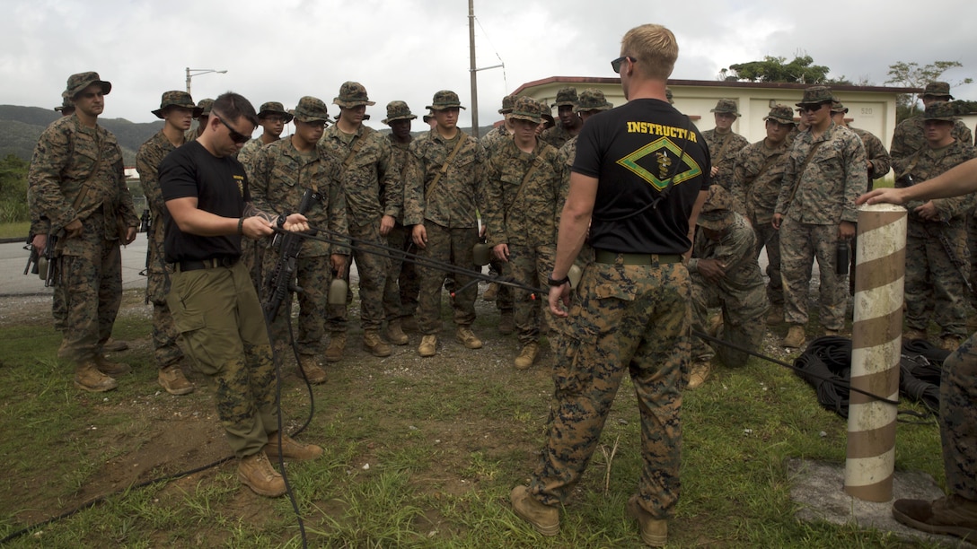 Instructors demonstrate how to set up a pulley system to retain equipment in the jungle Sept. 20 at the Jungle Warfare Training Center, Okinawa, Japan. The Jungle Warfare Training Center has provided terrain and climate-specific training to units serving across the Asia-Pacific region since 1958 and stretches over more than 17,000 acres. Training aboard the installation reinforces service members’ ability to carry out tactical operations in a jungle environment.