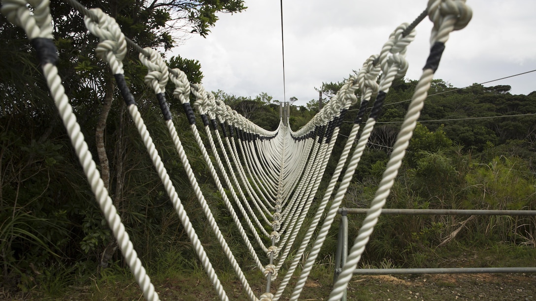 A three-strand obstacle sprawls over an open valley at the Jungle Warfare Training Center Sept. 20 on Okinawa, Japan. This obstacle is one of the 31 obstacles Marines must navigate during the culminating event of any JWTC course. JWTC is utilized for its harsh terrain and conditions to prepare Marines for operations in the Asia-Pacific Region and stretches over more than 17,000 acres.