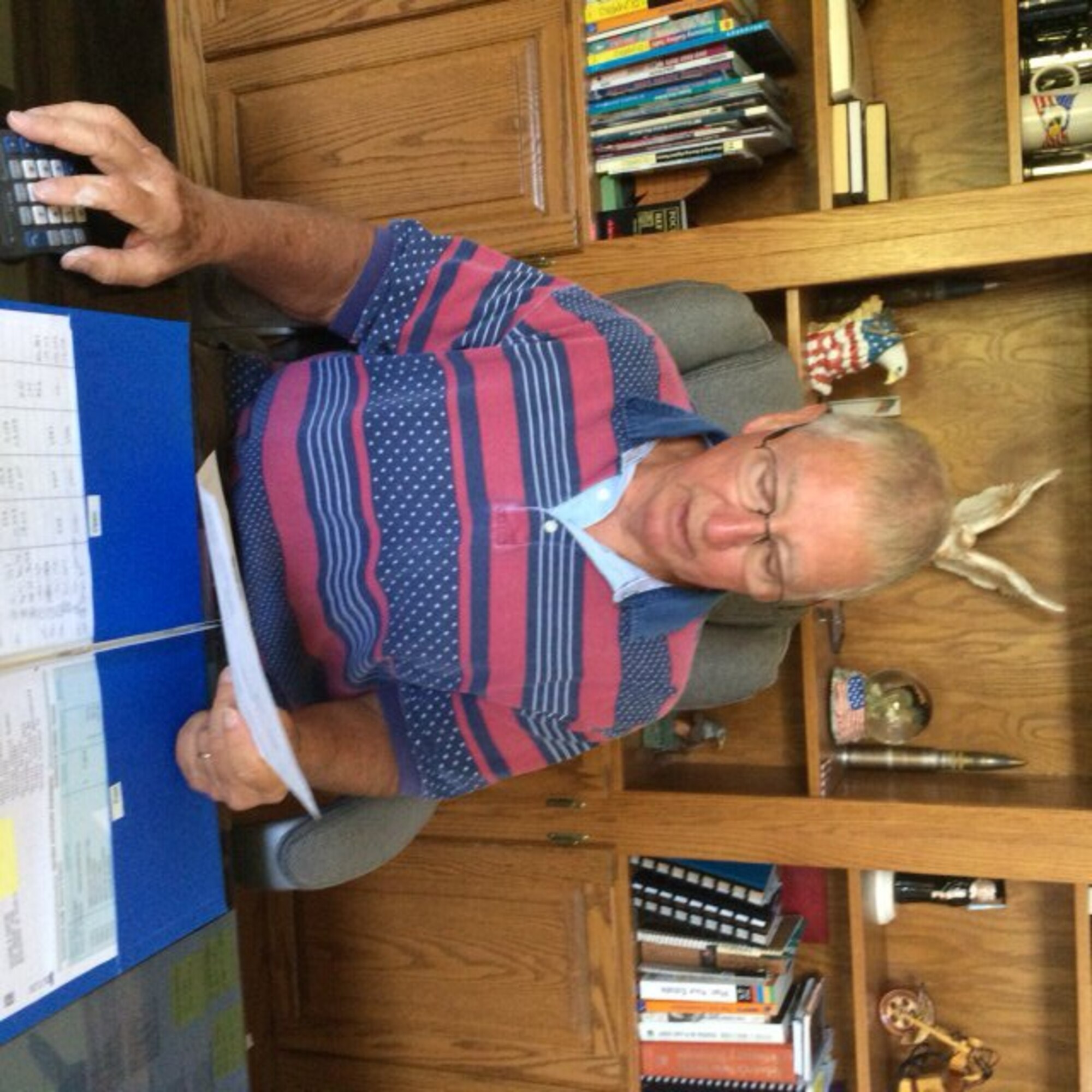 Retired Col. Rick Shapiro, director of the Retiree Activities Office, inspects forms for tax preparation. (U.S. Air Force photo / Sandy Simison)