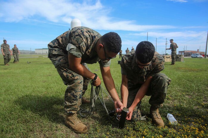 Marines check security ropes in preparation for the installation of a Meteorological Radar Subsystem at Marine Corps Air Station New River, N.C., Sept. 14, 2016. This MRS was installed by Marines with Meteorology and Oceanography platoon, 2nd Intelligence Battalion and Marine Air Traffic Control Detachment Bravo, Marine Air Traffic Control Squadron 2 and is free-standing and requires 12 ropes to properly secure it. (U.S. Marine Corps photo by Lance Cpl. Ashley Lawson/Released) 160914-M-IH158-080