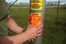 A Marine uses a leveling device to ensure a Meteorological Radar Subsystem is even with the ground at Marine Corps Air Station New River, N.C., Sept. 14, 2016.  The MRS, being leveled by Marines with Meteorology and Oceanography platoon, 2nd Intelligence Battalion and Marine Air Traffic Control Detachment Bravo, Marine Air Traffic Control Squadron 2, is used by forecasters to predict tropical storms and better understand cloud cover. (U.S. Marine Corps photo by Lance Cpl. Ashley Lawson/Released)