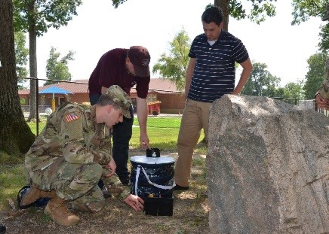 Army 1st Lt. Kyle Fortner, an environmental officer from Fort Lee, Virginia’s Kenner Army Health Clinic, installs a battery-operated mosquito collection system near the child development center July 19, 2016 on the Defense Supply Center Richmond, Virginia, while Defense Logistics Agency Installation Support at Richmond environmental staff members assist. Two traps collect mosquitos for Zika virus testing each week during the mosquito season. 