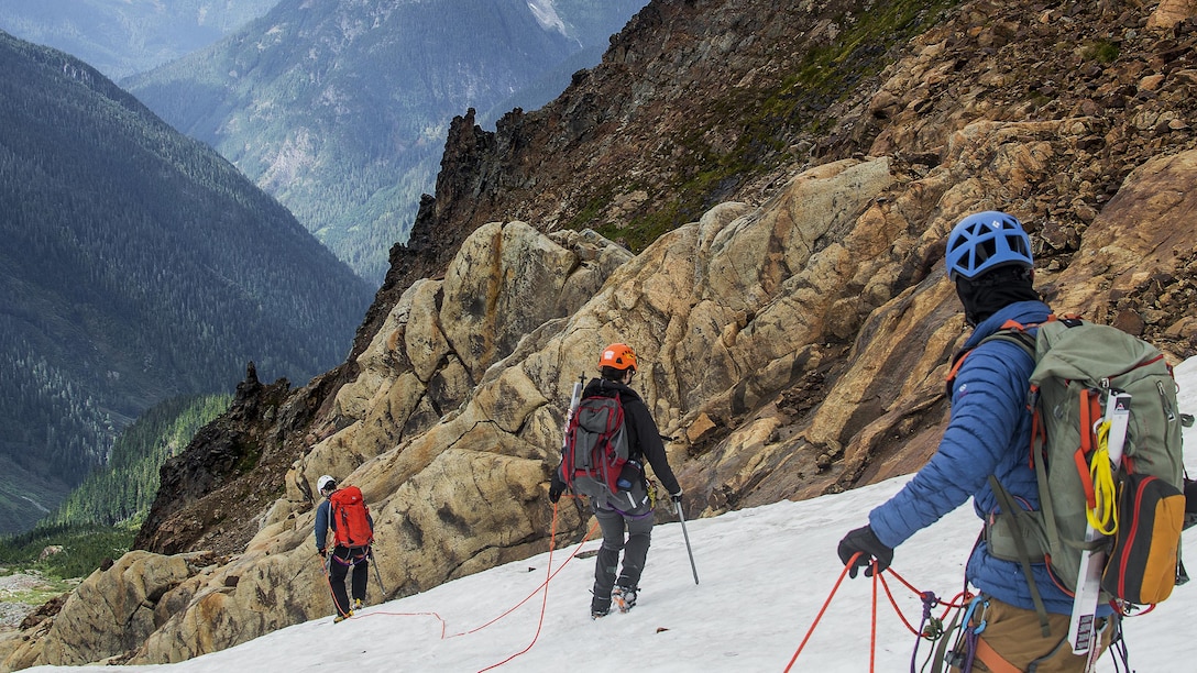 Colin Ayers (right), Melanie Stam (center) and Ben Stilin escape whiteout conditions on the Quien Sabe Glacier in North Cascades National Park, Washington, Sept. 10, 2016. After encountering an exhausted 77-year-old Norman Petty on a hike with his wife Barbara, photographer Capt. Nick Anthony, the pictured climbers and Catherine Mitchell (not pictured) led the couple visiting from Dunwoody, Georgia, to safety by transporting Norman Petty more than three miles using an impromptu support system. Anthony, from Norman, Oklahoma, is a U.S. Marine Corps recruiting management officer based in Seattle. Ayers, from Spokane, Washington, is a University of Washington chemical engineering student. Mitchell, from Seattle, is a content project manager at Microsoft. Stam, from Atlanta, is a Microsoft data analyst. Stilin, from Seattle, is a ski instructor at Husky Winter Sports.