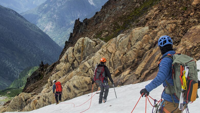 Colin Ayers (right), Melanie Stam (center) and Ben Stilin escape whiteout conditions on the Quien Sabe Glacier in North Cascades National Park, Washington, Sept. 10, 2016. After encountering an exhausted 77-year-old Norman Petty on a hike with his wife Barbara, photographer Capt. Nick Anthony, the pictured climbers and Catherine Mitchell (not pictured) led the couple visiting from Dunwoody, Georgia, to safety by transporting Norman Petty more than three miles using an impromptu support system. Anthony, from Norman, Oklahoma, is a U.S. Marine Corps recruiting management officer based in Seattle. Ayers, from Spokane, Washington, is a University of Washington chemical engineering student. Mitchell, from Seattle, is a content project manager at Microsoft. Stam, from Atlanta, is a Microsoft data analyst. Stilin, from Seattle, is a ski instructor at Husky Winter Sports.