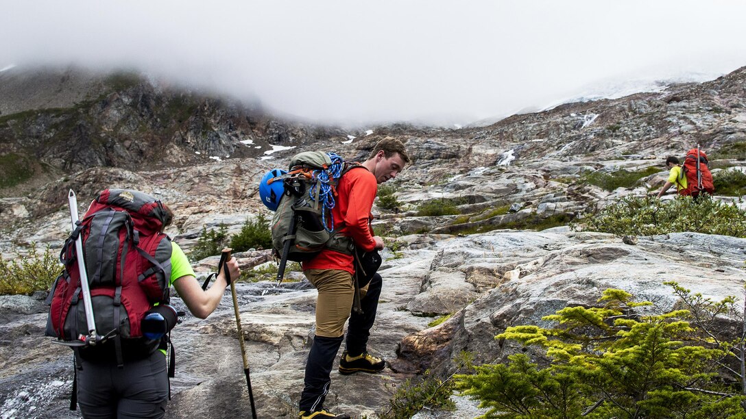 Melanie Stam (left), Colin Ayers (center) and Ben Stilin (left) ascend toward the Quien Sabe Glacier in North Cascades National Park, Washington, Sept. 10, 2016. After encountering an exhausted 77-year-old Norman Petty on a hike with his wife Barbara, photographer Capt. Nick Anthony, the pictured climbers and Catherine Mitchell (not pictured) led the couple visiting from Dunwoody, Georgia, to safety by transporting Norman Petty more than three miles using an impromptu support system. Anthony, from Norman, Oklahoma, is a U.S. Marine Corps recruiting management officer based in Seattle. Ayers, from Spokane, Washington, is a University of Washington chemical engineering student. Mitchell, from Seattle, is a content project manager at Microsoft. Stam, from Atlanta, is a Microsoft data analyst. Stilin, from Seattle, is a ski instructor at Husky Winter Sports.