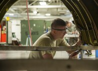 Senior Airman Adam Hess, 5th Maintenance Squadron aircraft structural maintenance journeyman, drills an aircraft part for a B-52H Stratofortress engine cowl at Minot Air Force Base, N.D., Sept. 20, 2016. Structural maintenance is responsible for repairing physical damage to B-52 Stratofortresses. (U.S. Air Force photo/Airman 1st Class Christian Sullivan)