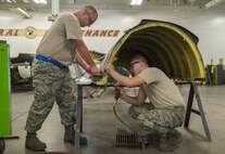 Master Sgt. Jeffrey Kinlaw and Senior Airman Adam Hess, 5th Maintenance Squadron aircraft structural maintenance members, hand-form and drills an aircraft part for a B-52H Stratofortress engine cowl at Minot Air Force Base, N.D., Sept. 20, 2016. The 5th MXS provides Minot AFB with munition maintenance, aircraft maintenance and maintenance operations support. (U.S. Air Force photo/Airman 1st Class Christian Sullivan)