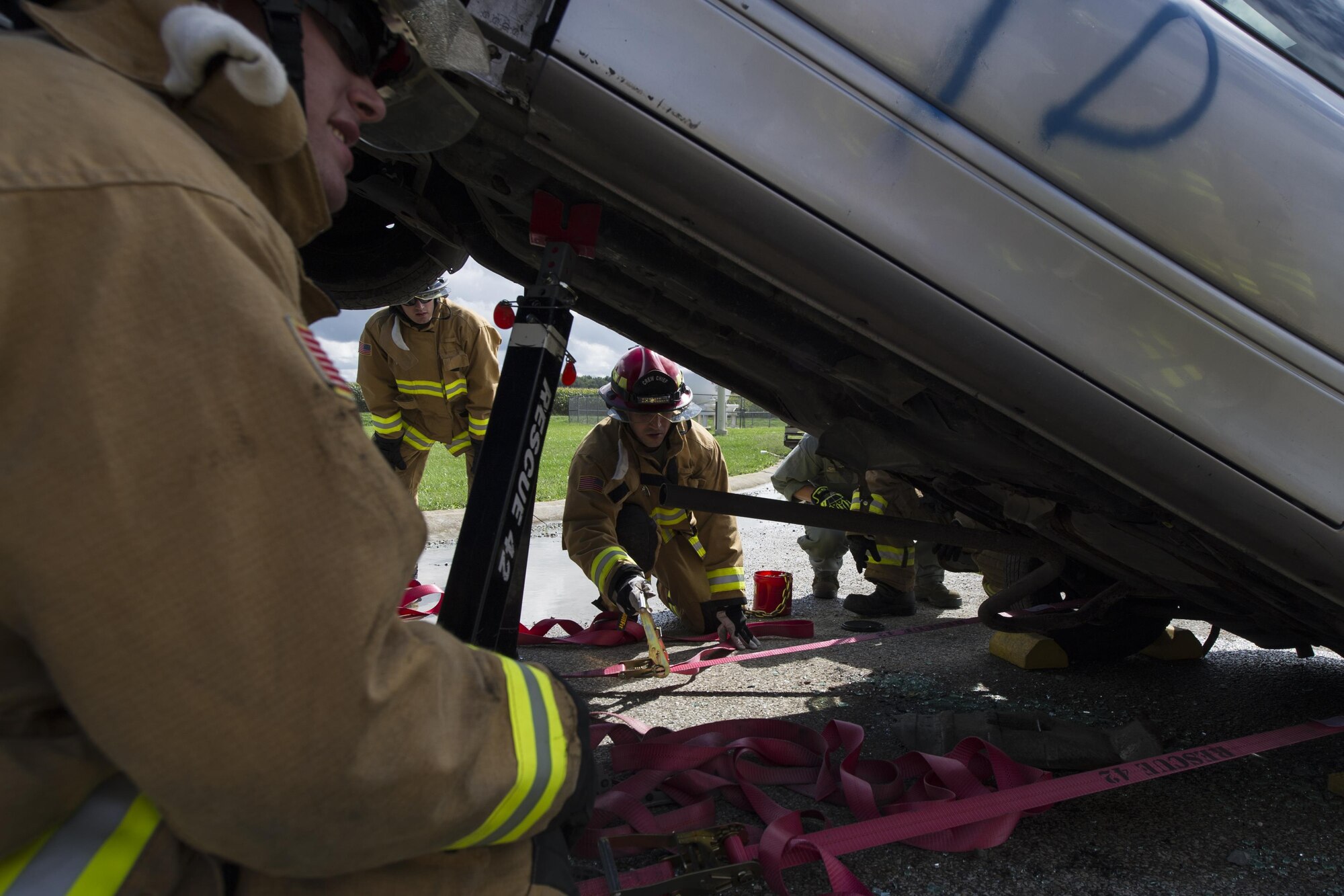 Staff Sgt. Nicholas Delaurentis, 434th Civil Engineer Squadron firefighter, adjusts struts to stabilize a vehicle in a simulated auto accident during an exercise Sept. 10, 2016 at Grissom Air Reserve Base, Ind. The exercise provided a unique training opportunity for CES Airmen. (U.S. Air Force photo/Staff Sgt. Katrina Heikkinen)