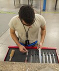 Airmen 1st Class Dustin Pace, 5th Maintenance Squadron aircraft structural maintenance apprentice, pulls out a file at Minot Air Force Base, N.D., Sept. 20, 2016. The files are used to smooth out the rough edges on metal aircraft parts. (U.S. Air Force photo/Airman 1st Class Christian Sullivan)