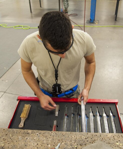 Airmen 1st Class Dustin Pace, 5th Maintenance Squadron aircraft structural maintenance apprentice, pulls out a file at Minot Air Force Base, N.D., Sept. 20, 2016. The files are used to smooth out the rough edges on metal aircraft parts. (U.S. Air Force photo/Airman 1st Class Christian Sullivan)