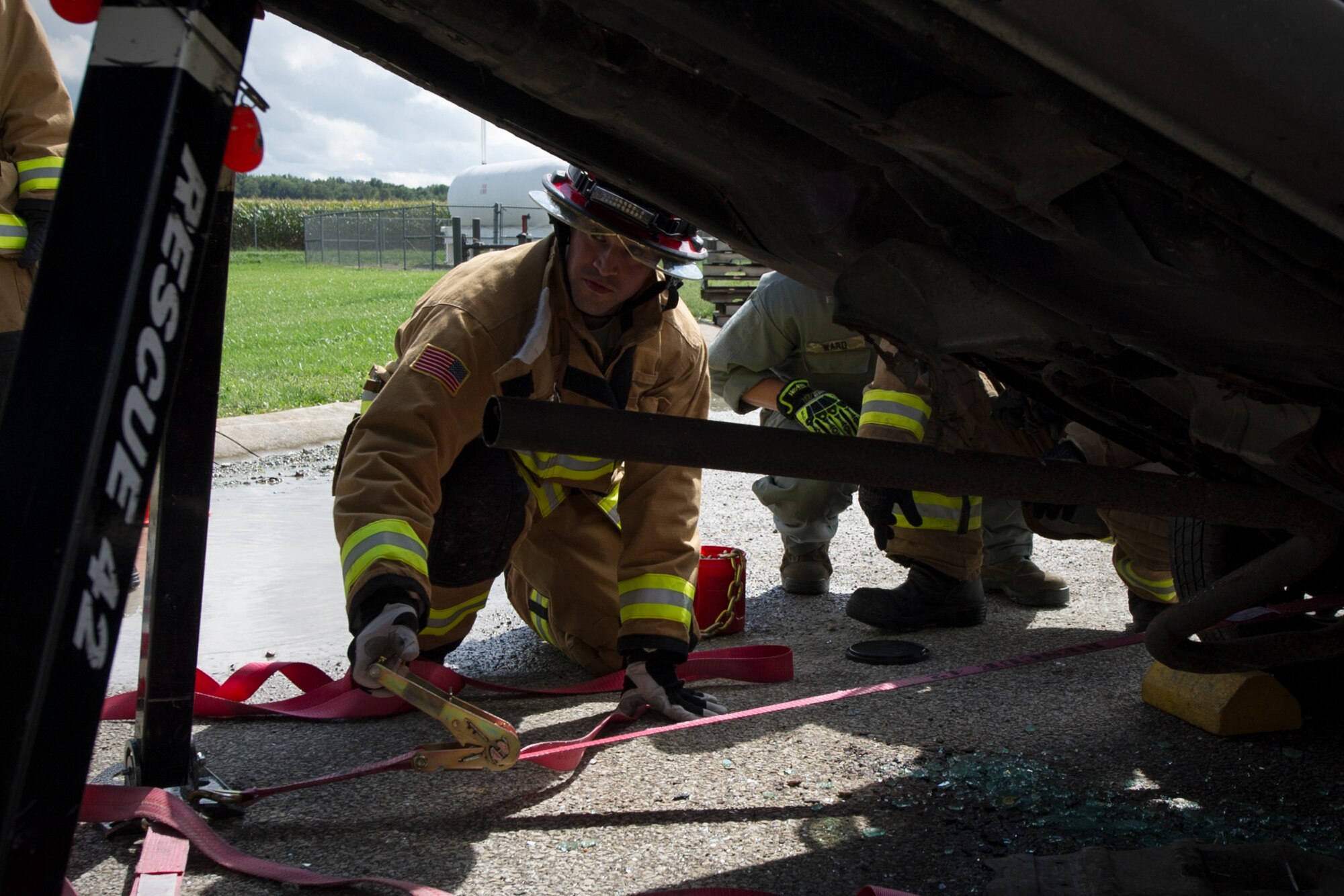 Staff Sgt. Nicholas Delaurentis, 434th Civil Engineer Squadron firefighter, adjusts struts to stabilize a vehicle in a simulated auto accident during an exercise Sept. 10, 2016 at Grissom Air Reserve Base, Ind. The exercise provided a unique training opportunity for CES Airmen. (U.S. Air Force photo/Staff Sgt. Katrina Heikkinen)