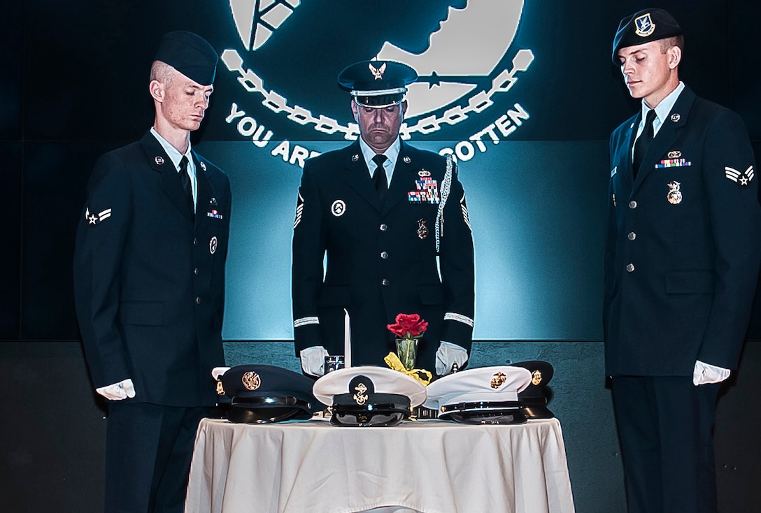 An empty table set for one sits on the stage as members of the Ohio National Guard present the Table of Remembrance toast in honor of our POW/MIAs. 