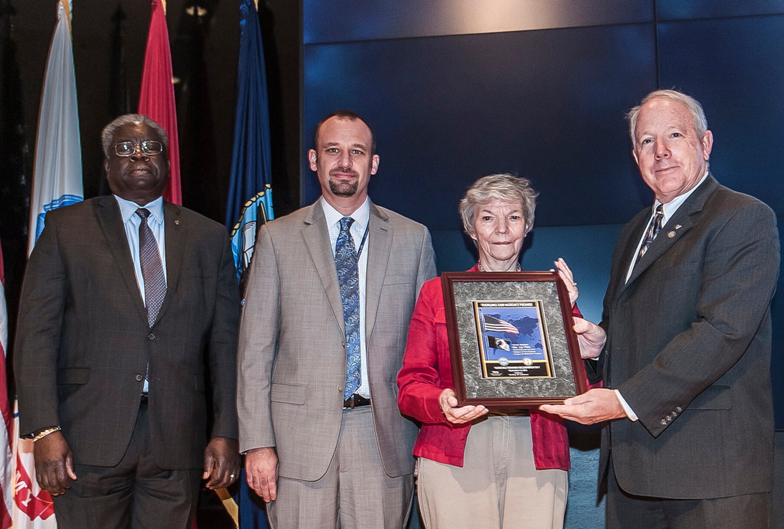 Defense Supply Center Columbus honored National POW/MIA day Sept. 16 inside the Building 20 Auditorium. Pictured are (l-r): Milton Lewis, DLA Land and Maritime acquisition executive; David Glover, DFAS-Columbus; Liz Flick, regional coordinator, The National League of POW/MIA Families; and James McClaugherty, acting commander, DLA Land and Maritime. 