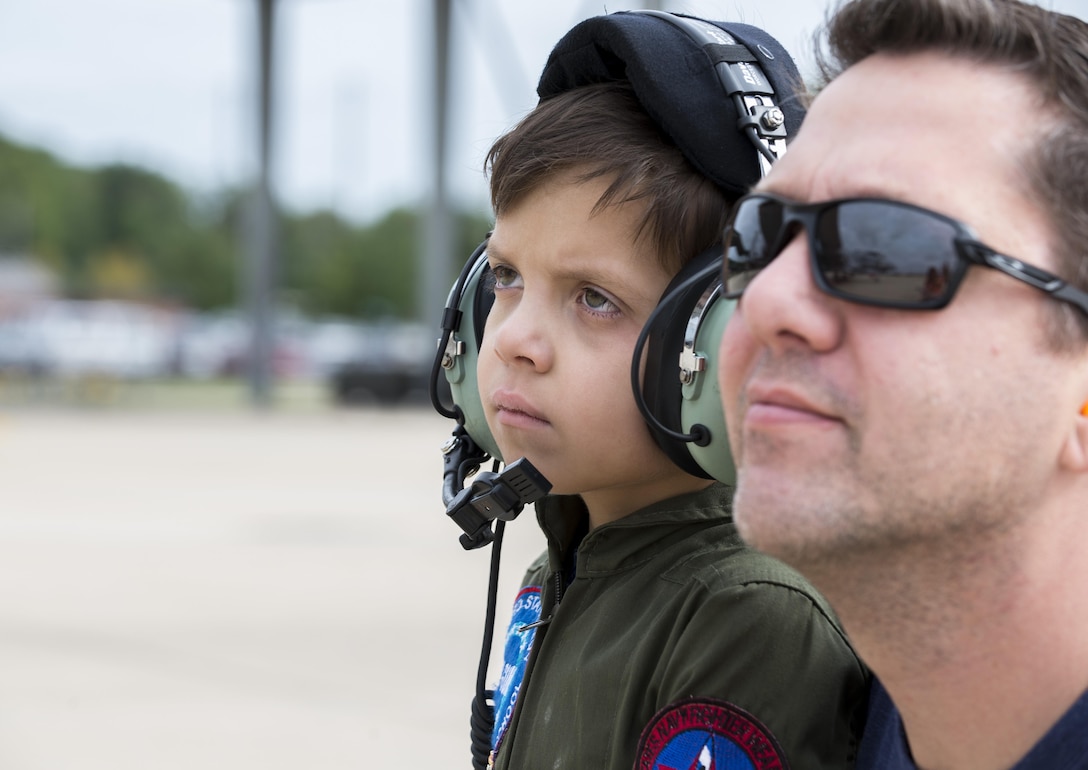 Jack Kirkbride and his dad watch an  A10 Thunderbolt II, from the 104th Fighter Wing, taxi at the Warfield Air National Guard Base in Middle River, Maryland, Sept. 17, 2016. The Pilot of the Day program was coordinated through the 175th Wing and the Gold in Fight Foundation.
