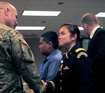 Army 2nd Lt. Trang Jorgensen, assigned to the Iowa Army National Guard’s Headquarters and Headquarters Company, 1st Battalion, 168th Infantry, shakes hands with Army Lt. Col. Aaron Baugher, commander of the battalion, after receiving her commission as an infantry officer during a ceremony at Camp Dodge Joint Maneuver Training Center in Johnston, Iowa. Jorgensen is the first female officer in the Iowa Army National Guard to select a combat arms branch. 