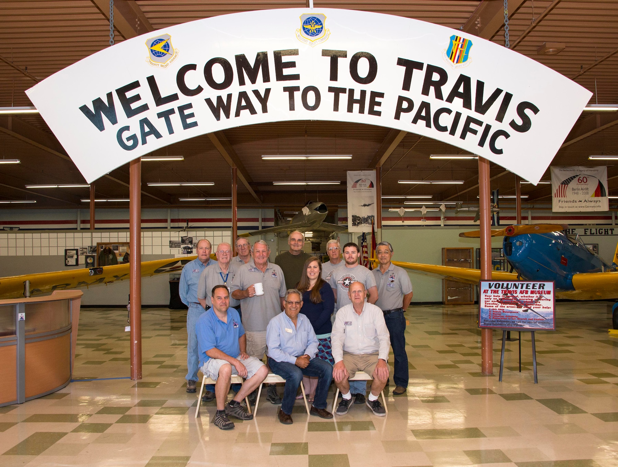 Volunteers from the Travis Heritage Center pose for a group photo Sept. 22, 2016 at Travis Air Force Base, Calif. The Travis Heritage Center has a variety of historic airlift aircraft on display, assorted exhibits pertaining to military operations and a picnic area. The Heritage Center also has a Gift shop designed to make your visit a lasting memory. (U.S. Air Force photo by Staff Sgt. Charles Rivezzo)