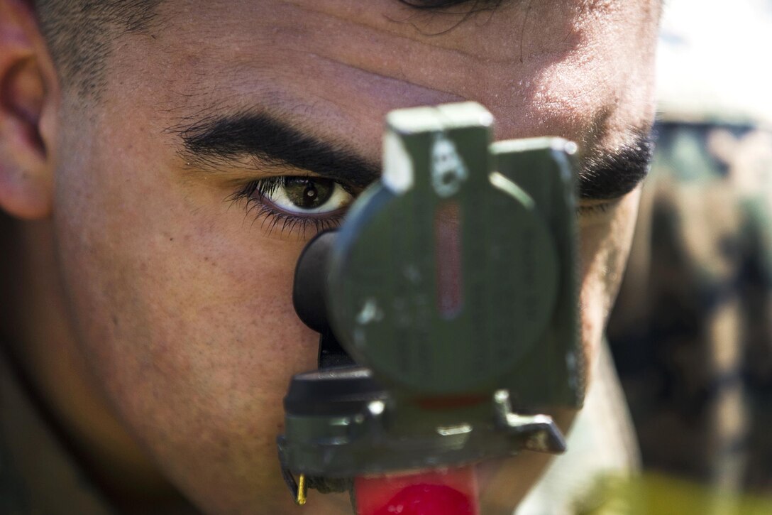 Marine Corps Lance Cpl. Fernando A. Castillo aligns targeting reference points to ensure accurate fire with 81 mm mortars during training on Farallon de Medinilla Range, Northern Mariana Islands, Sept. 16, 2016. Castillo is a mortarman assigned to Weapons Company, Battalion Landing Team, 2nd Battalion, 4th Marine Regiment, 31st Marine Expeditionary Unit. Marine Corps photo by Staff Sgt. T.T. Parish