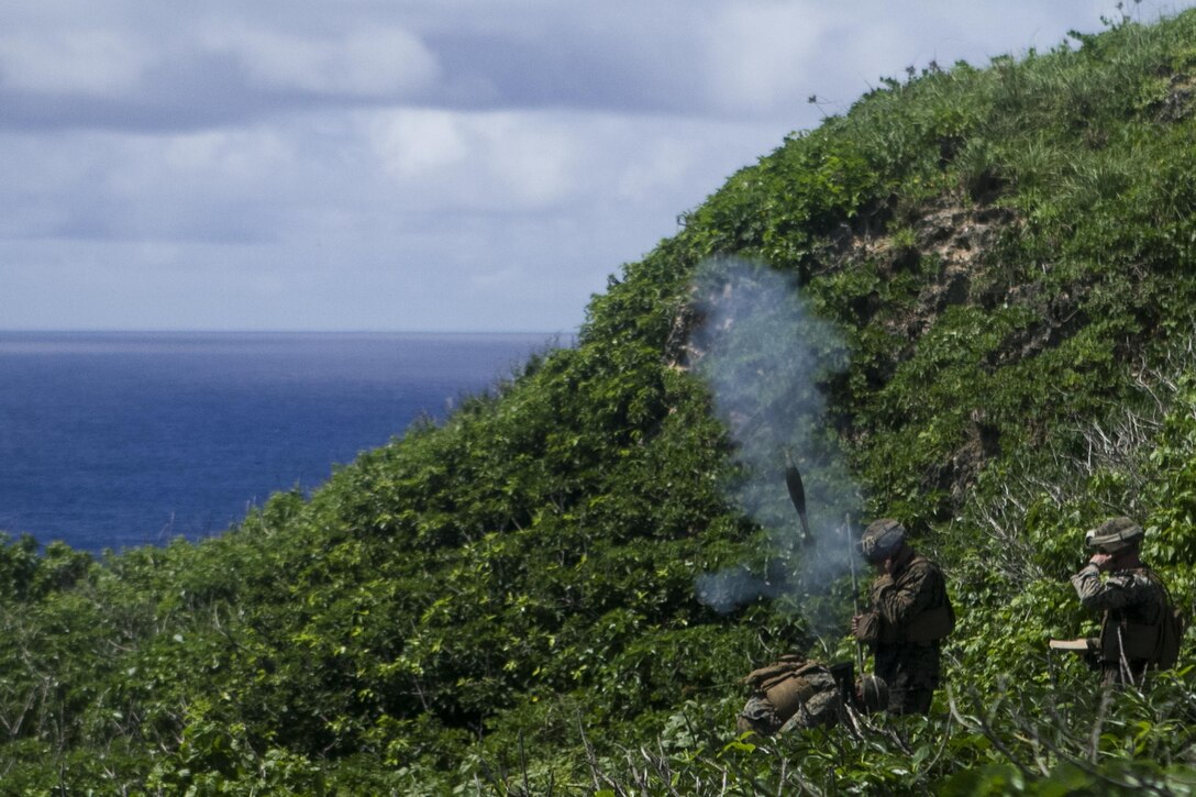 Marines fire an 81 mm mortar from the side of a mountain during training at Farallon de Medinilla Range, Northern Mariana Islands, Sept. 16, 2016. Marine Corps photo by Staff Sgt. T.T. Parish