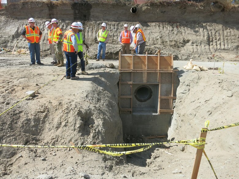 Corps members inspect a recently-poured flap-gate that will allow drainage into Murrieta Creek during a Sept. 22 visit to the project by Los Angeles District Commander Col. Kirk Gibbs.