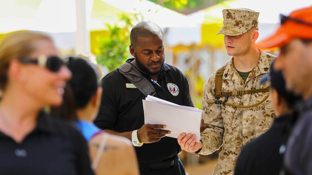 U.S. Marine Sgt. Levi Hodge with the 22nd Marine Expeditionary Unit and a member of the local guard force escort U.S. and international citizens during a bilateral non-combatant evacuation exercise at the U.S. Embassy, Muscat, Oman, Sept. 21, 2016. The non-combatant evacuation exercise is an opportunity for the United States and Oman to practice a bilateral mission of quickly providing security and safety to U.S. and international citizens abroad during a natural disaster or contingency. 