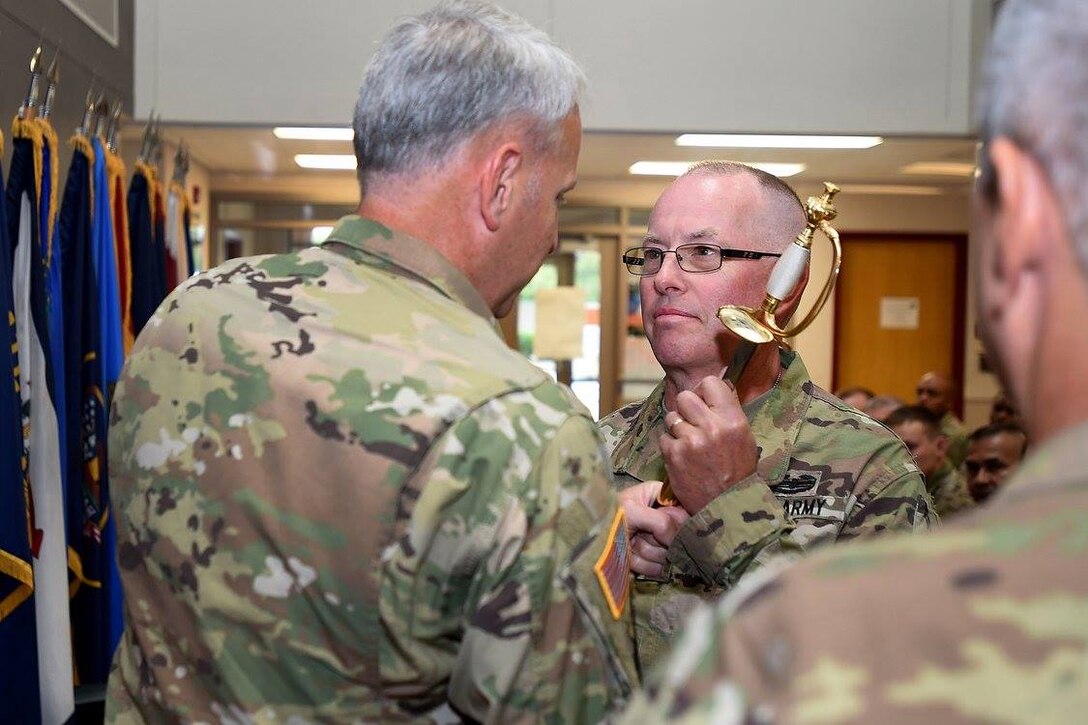 Army Reserve Command Sgt. Maj. Vernon Perry, right, receives the noncommissioned officer's sword during the 85th Support Command's Change of Responsibility where Command Sgt. Maj. Kevin Greene relinquished responsibility to Perry, September 10, 2016.
(Photo by Sgt. Aaron Berogan)
