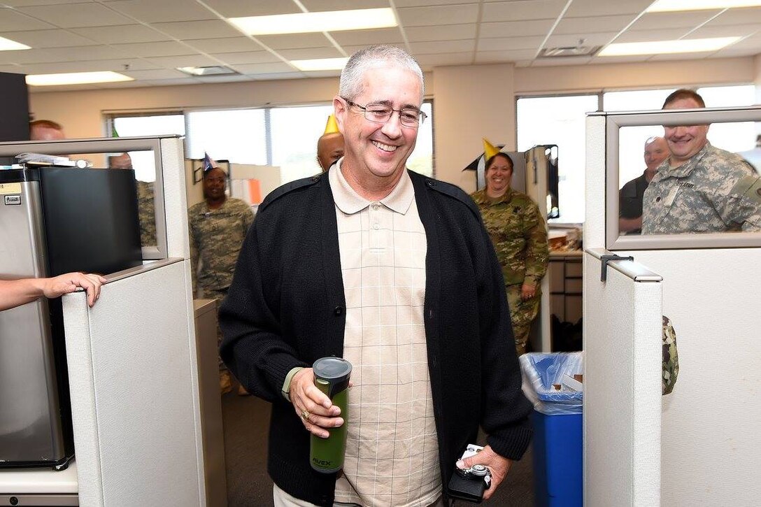 Mr. Kevin Greene, Staff Operations and Training Specialist, 85th Support Command, smiles after seeing his birthday cake during a surprise birthday luncheon for Greene, September 12, 2016. Greene also served as the command's command sergeant major until recently where he relinquished responsibility to the new incoming command sergeant major, Command Sgt. Maj. Vernon Perry.
(Photo by Mr. Anthony L. Taylor)