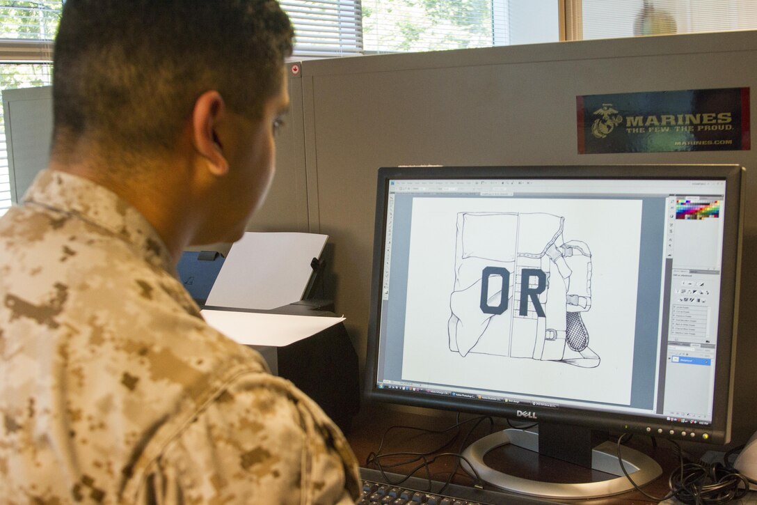 Sgt. John A. Martinez reviews the design he submitted for a ‘military athlete’ themed t-shirt design competition. Gunnery Sgt. Troy Campbell reached out to Martinez after hearing about the competition and inspired him to make his design after the motto 'Rack or Ruck'. The motto is a metaphor for the decisions that either contribute toward bettering yourself or following the status quo. Campbell is the procurement chief for Operations at Marine Corps Recruiting Command, and is a native of Madison Heights, Va. Martinez is the graphics illustrator for MCRC, and is a Houston, Texas native.