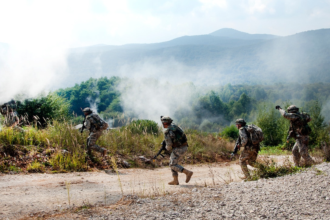 U.S. soldiers cross a road under the cover of smoke to assault an objective during a deliberate attack drill as part of exercise Immediate Response 16 at the armed forces training area in Slunj, Croatia, Sept. 14, 2016. Army photo by Staff Sgt. Opal Vaughn