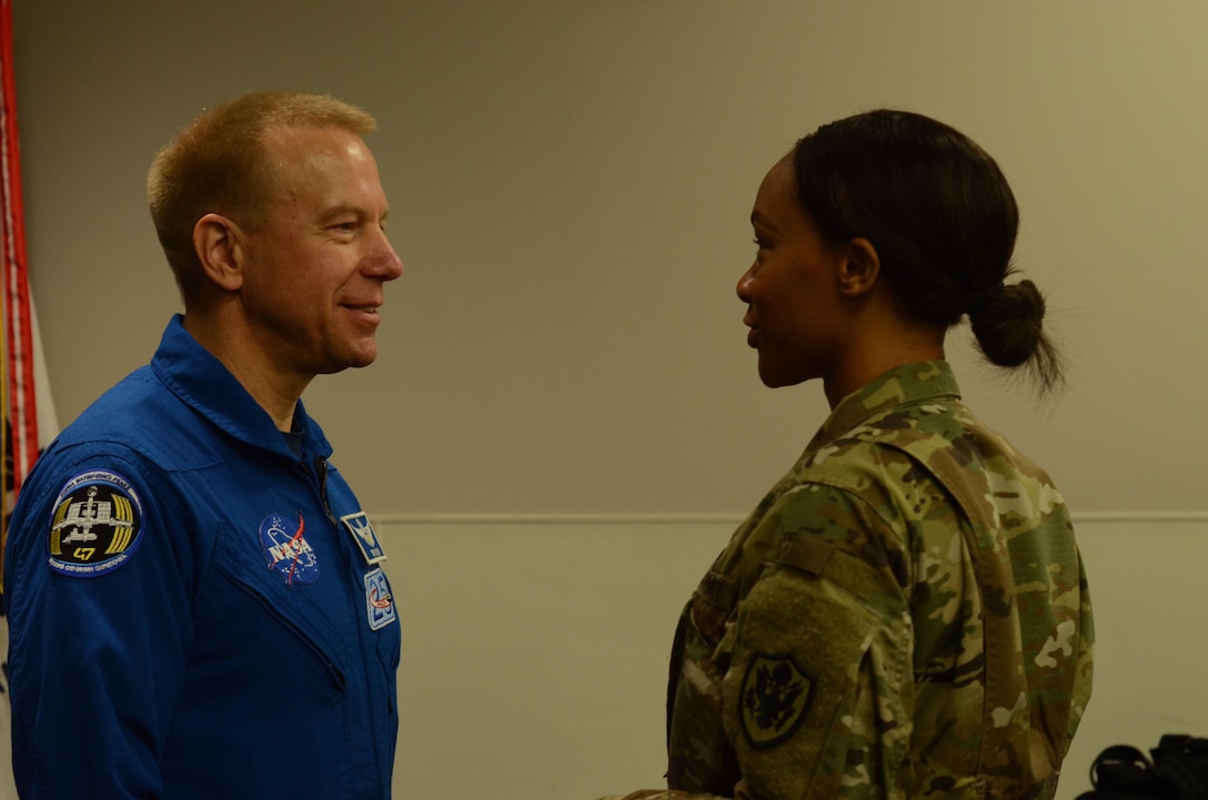 Staff Sgt. Candice Funchess (right), a Defense Information School journalism instructor, welcomes NASA astronaut Timothy Kopra (left) to the school on Fort Meade, Md., Sept. 13, 2016. Kopra’s presentation unveiled his unique experiences aboard the International Space Station.