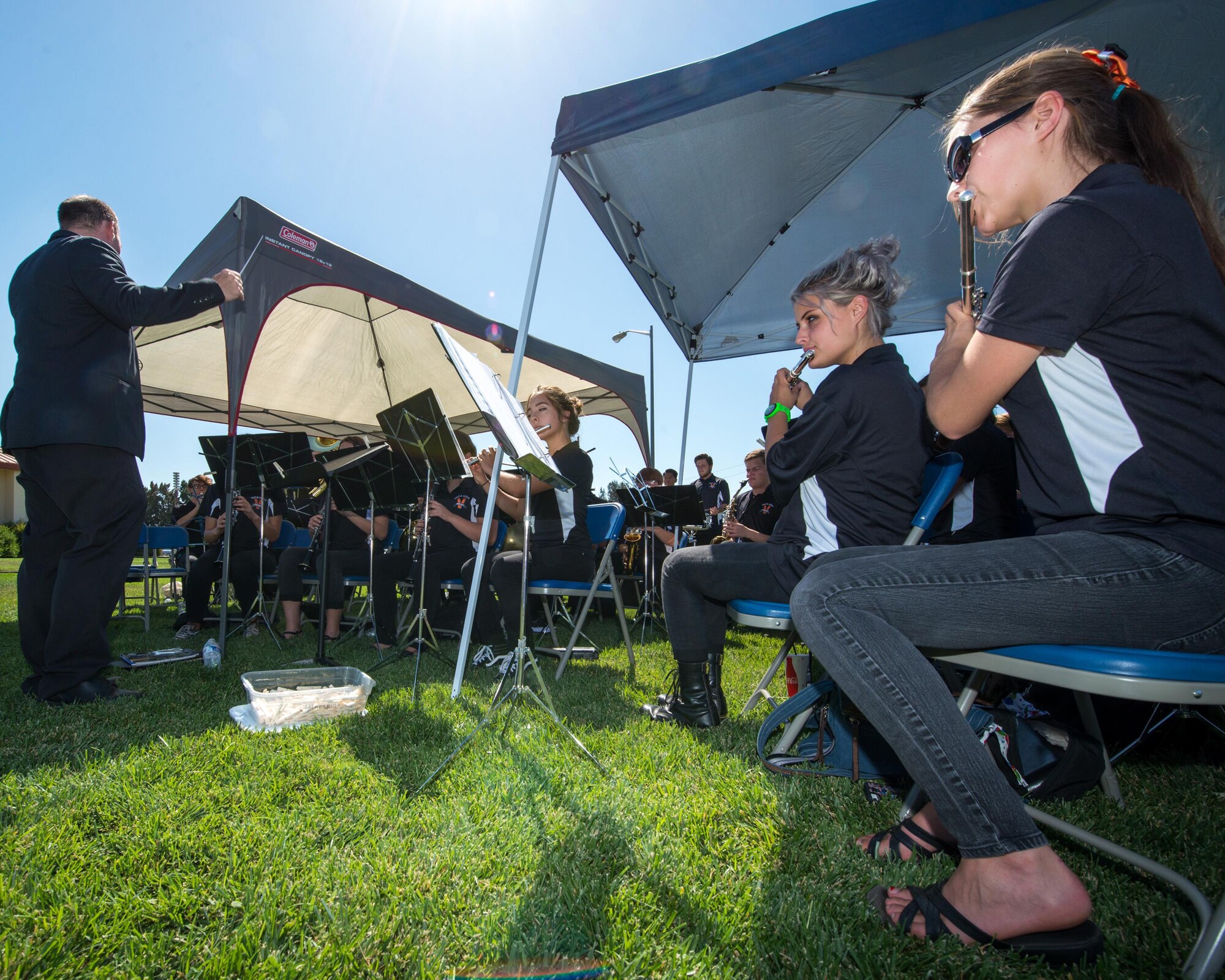 Andy Herout conducts the Vacaville High School Band during the POW/MIA Remembrance Ceremony at Travis Air Force Base, Sept. 16, 2016. The ceremony was held in honor of POW/MIA Recognition Day which honors former prisoners of war and the more than 83,000 American troops missing in action since WW II. (U.S. Air Force photo by Louis Briscese)