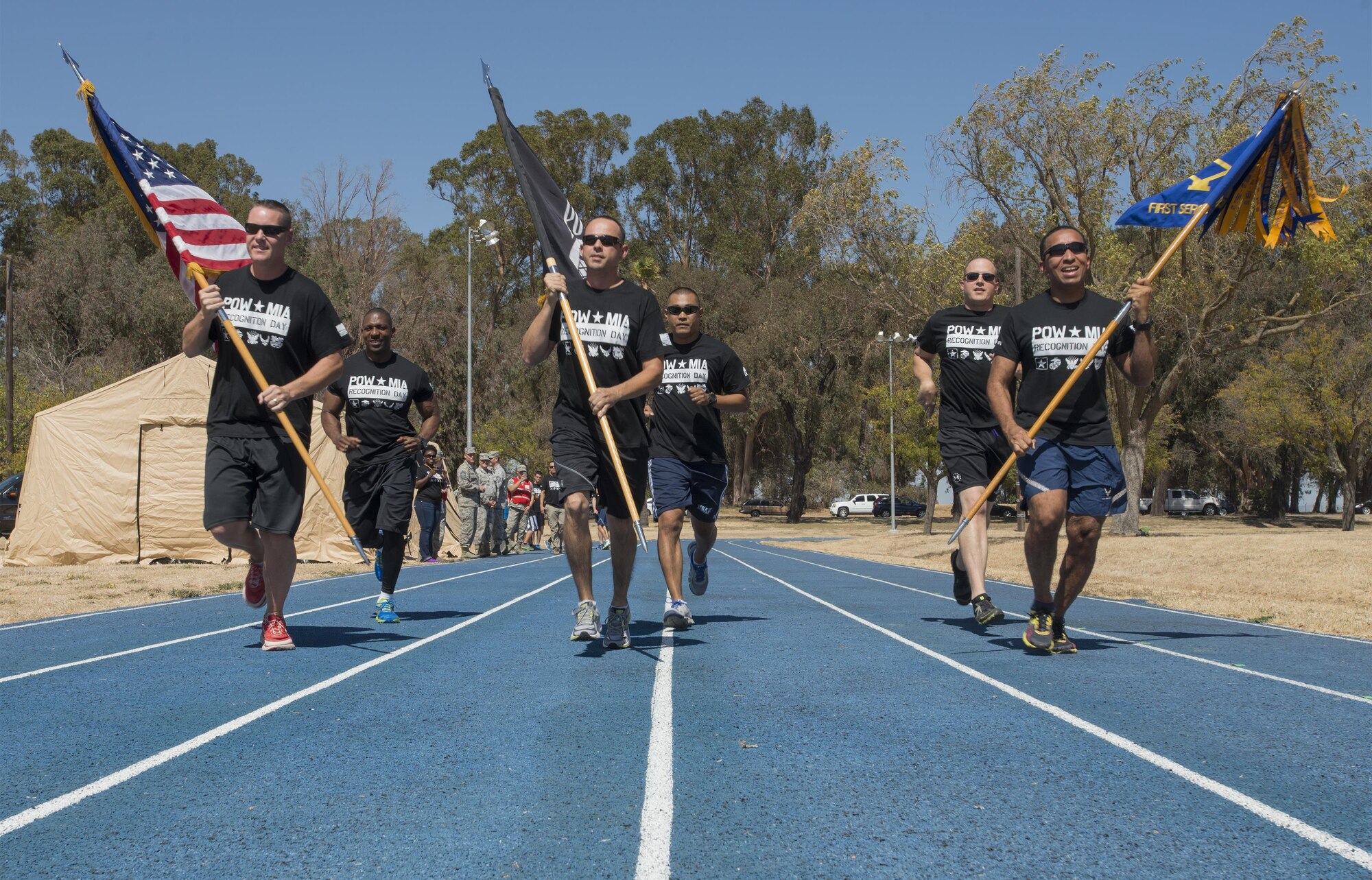 Master Sgt. William Mitchell, 60 Civil Engineer Squadron first sergeant, (middle) carries the Prisoner of War/Missing in Action Flag as he runs with a group of his fellow Travis Air Force Base first sergeants during the annual POW/MIA Remembrance Run, Sept. 14, 2016. (U.S. Air Force Photo by Heide Couch)