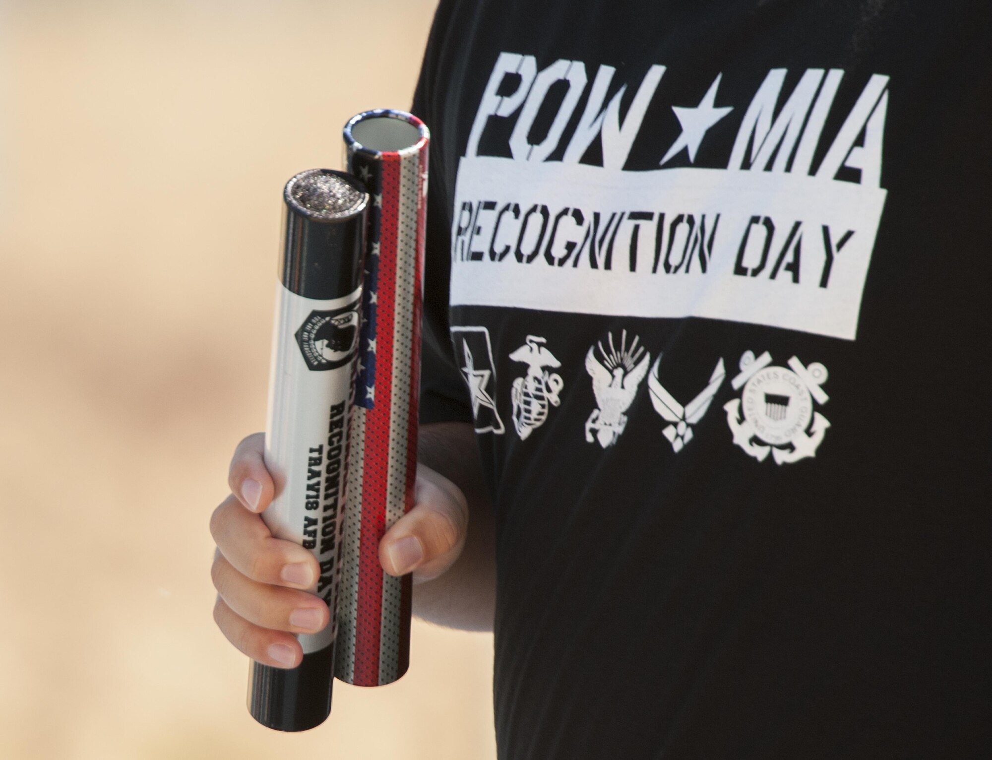 Airmen assigned to the 821st Contingency Response Squadron run on blue track with Prisoner of War/Missing in Action batons Sept. 15, 2016, at Travis Air Force Base, California. The 24-hour run was held as part of POW/MIA Recognition Day. The POW/MIA baton holds a flash drive that contains all known names of all the accounted for POW/MIAs since WWI. (U.S. Air Force Photo by Heide Couch)