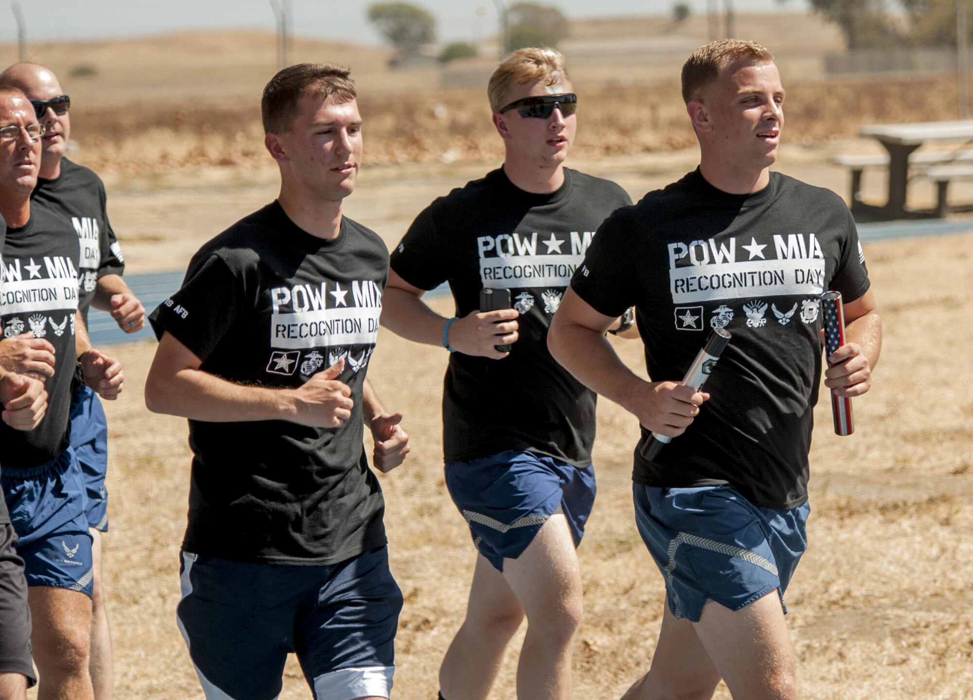 Airmen assigned to the 821st Contingency Response Squadron run on blue track with Prisoner of War/Missing in Action batons Sept. 15, 2016, at Travis Air Force Base, California. The 24 hour run was held as part of POW/MIA Recognition Day. . The POW/MIA baton holds a flash drive that contains all known names of all the accounted for POW/MIAs since WWI. (U.S. Air Force Photo by Heide Couch)