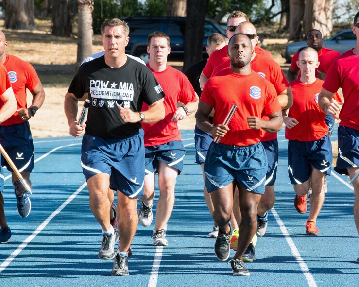 U.S. Air Force Senior Airman Brandon Bland, 9th Airlift Squadron, runs with U.S. Air Force Col. John Klein, 60th Air Mobility Wing commander, during the 24-hour Prisoner of War/Missing in Action Remembrance Day Run, Sept. 16, 2016. The POW/MIA Remembrance Day Run is an annual event that remembers former prisoners of war and the more than 83,000 American troops missing in action since WW II. (U.S. Air Force photo by Louis Briscese)